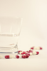 medication tablets beside drinking glass thumbnail