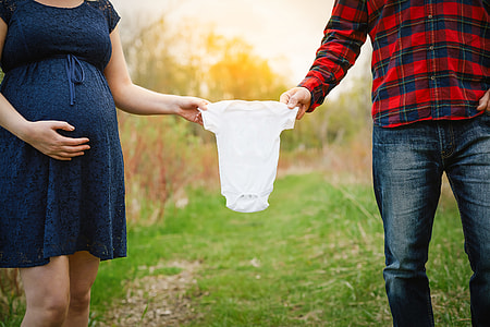 man and woman holding baby's onesie thumbnail