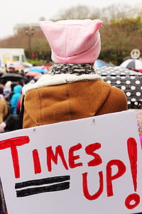 person with times up signage hanged on hoodie thumbnail