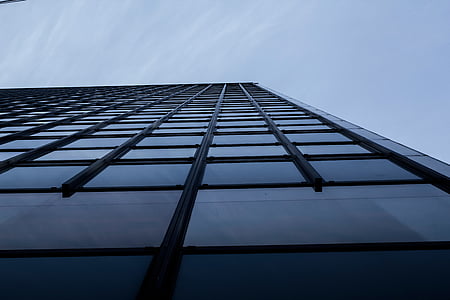 low angle photography of gray building under white sky thumbnail