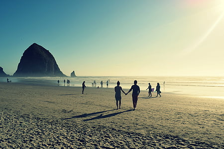 people standing on seashore thumbnail