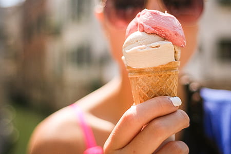 person holding coned ice cream thumbnail
