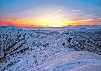 aerial photography of snow-capped mountain at sunset thumbnail