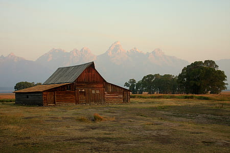 landscape photography of brown house surrounded by mountains thumbnail