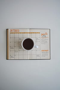 white cup of coffee on oktober calendar thumbnail