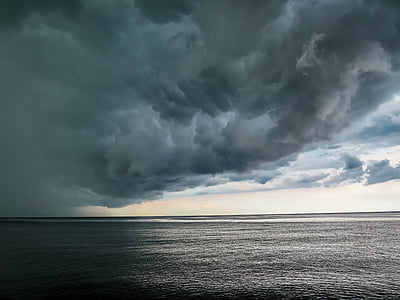 calm water large body of water under white and blue cloudy skies thumbnail
