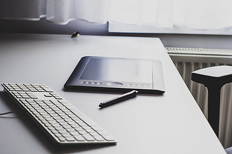 black tablet with pen on table thumbnail