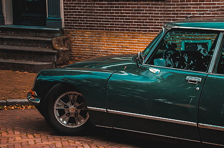 classic green car near stairs thumbnail