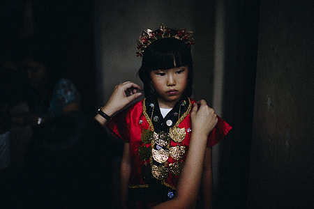girl wearing red and gold traditional clothing thumbnail