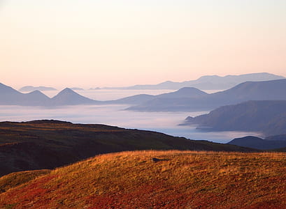 brown mountain near body of water thumbnail