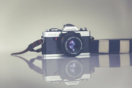 black and silver Minolta DSLR camera thumbnail