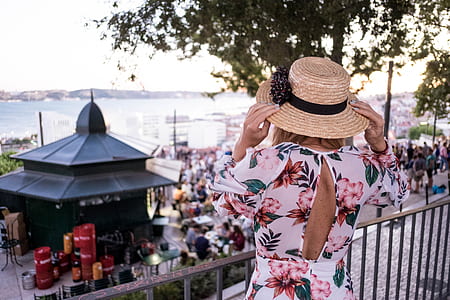 woman wearing floral dress looking at group of people dining thumbnail