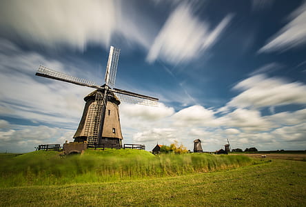 brown windmill under blue sky thumbnail