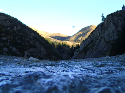 body of water in the middle of mountain during daytime thumbnail