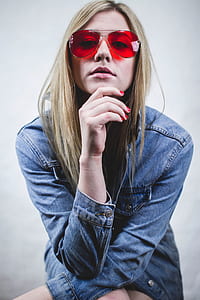 woman in red lens sunglasses wearing blue chambray jacket thumbnail