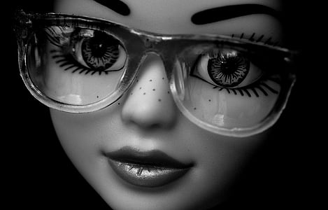 grayscale photo of doll wearing eyeglasses thumbnail