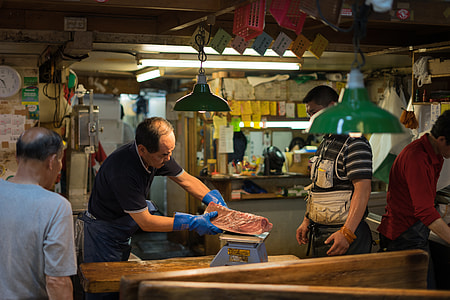 man putting meat on weighing scale thumbnail