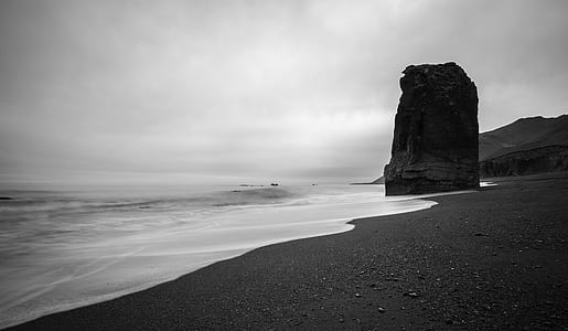 grayscale photo of seashore and cliff during daytime thumbnail
