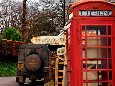 blue vehicle near red telephone booth thumbnail