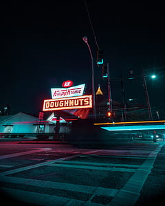 turned on Krispy Kreme doughnuts signage during nighttime thumbnail