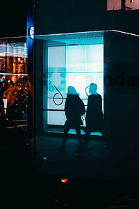 reflection of two person walking on sidewalk thumbnail