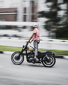 man riding bobber motorcycle while riding thumbnail
