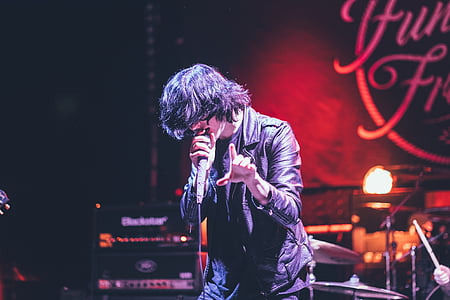 man singing on stage thumbnail