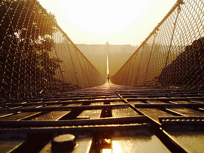 brown wooden foot bridge under sunny sky thumbnail