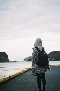 person standing on concrete flooring under white clouds during daytime thumbnail