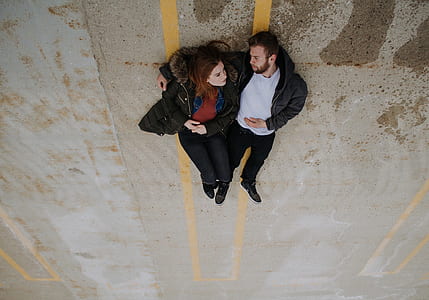 woman and man laying on road thumbnail