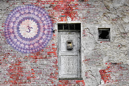 gray wooden 2-panel door surrounded by gray concrete walls thumbnail