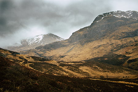 brown high-rise mountain under cloudy sky at daytime thumbnail