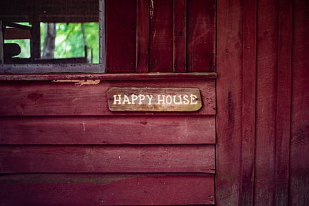 brown Happy House signboard mounted to red wooden wall thumbnail