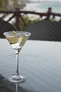 clear martini glass filled with clear liquid thumbnail