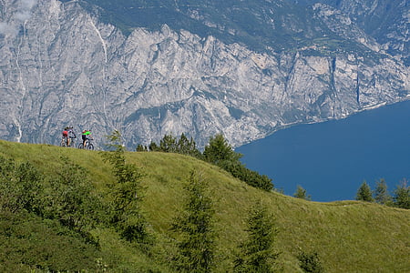 panoramic photo of people biking on cliff thumbnail
