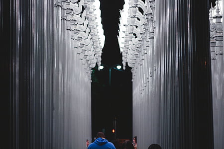 man standing between pillars thumbnail