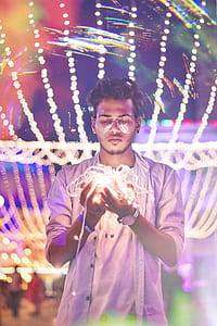 Man Holding String Light during Nighttime thumbnail