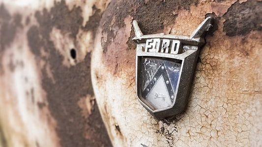 classic Ford emblem on rusted vehicle thumbnail