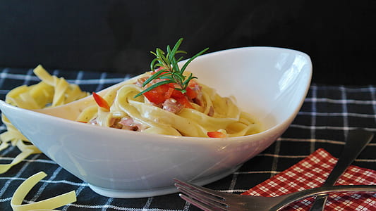oval white ceramic bowl beside fork thumbnail