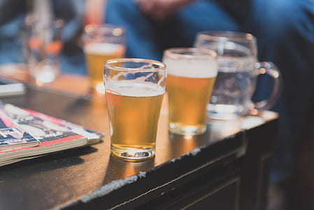 two glasses with beer placed on table thumbnail
