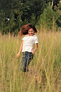 Woman Jumping Between Grass thumbnail