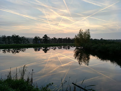 calm body of water under blue sky thumbnail