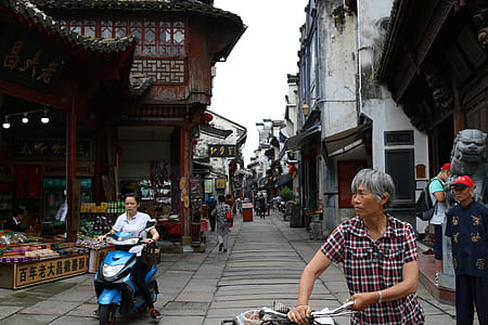 woman holding bike under cloudy sky at daytime thumbnail