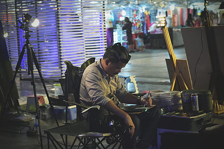man sitting down while writing thumbnail