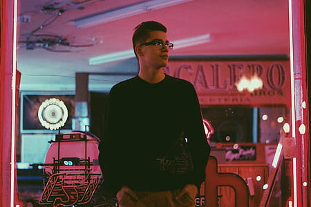 man surrounded by red neon lights thumbnail