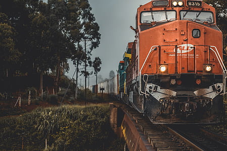 orange train traveling during sunset thumbnail