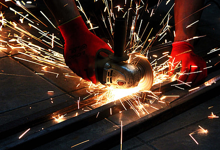 person using angle grinder on steel frame thumbnail