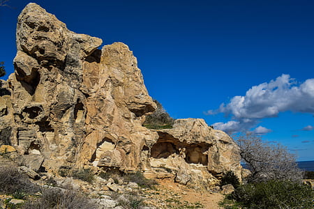 rock formation beside body of water thumbnail