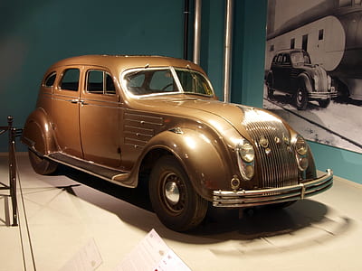 classic gold vehicle parked inside room thumbnail