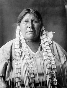 grayscale photo of woman wearing Native American attire thumbnail